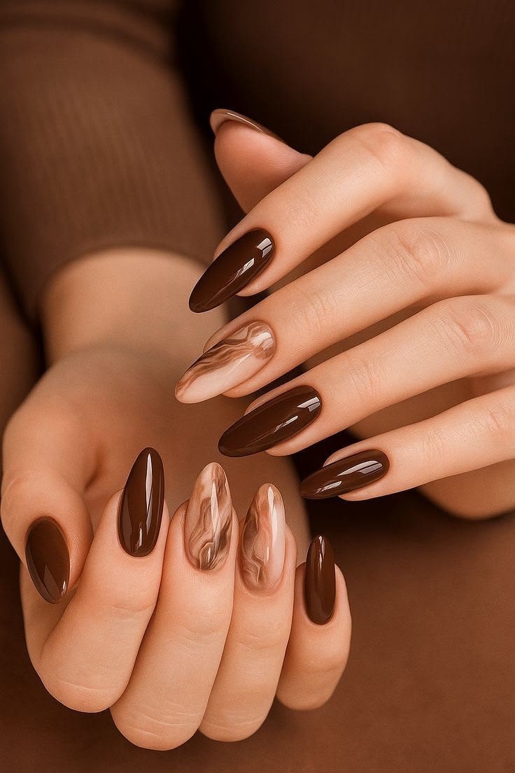 Glossy chocolate brown almond nails with marble accent nails