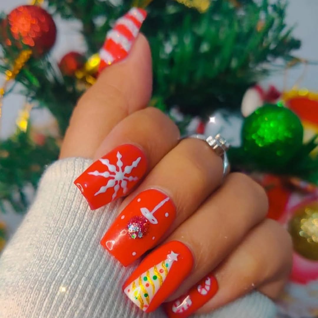 Red and white Christmas nail art with snowflake detail