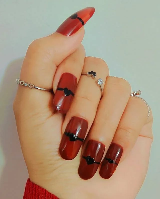 Deep red and burgundy almond nails with a glossy finish