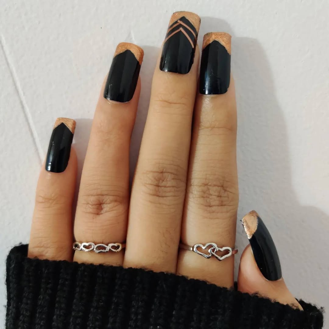 Matte black and nude nails with geometric chevron tips